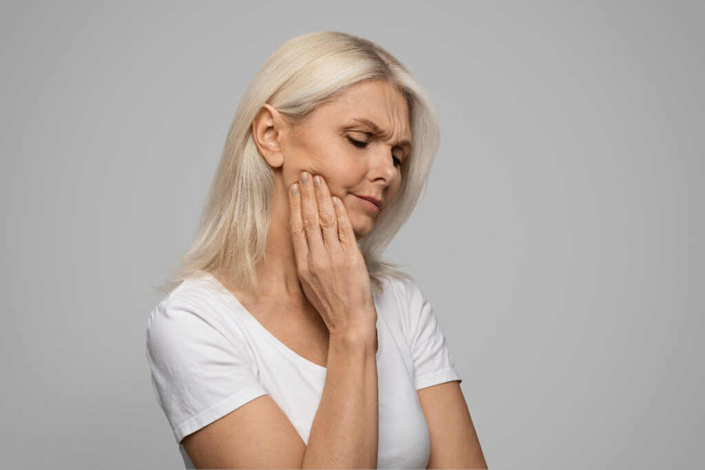 Can Wisdom Teeth Cause Headaches? Patient experiencing jaw pain that may be related to impacted wisdom teeth.