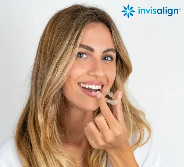 Smiling woman demonstrating results with Invisalign clear aligners in Chelmsford, MA.