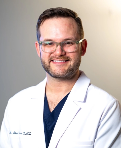 Portrait of Dr. Shah smiling in a white coat