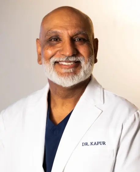 Dr. Ashim Kapur, dentist at Chelmsford dental practice, smiling in professional portrait.