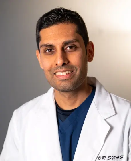 Dr. Himanshu Saar, dentist at Chelmsford dental practice, smiling in professional portrait.