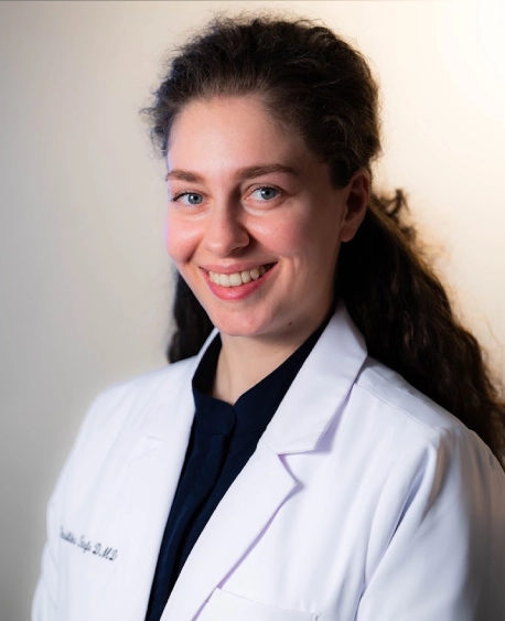 Portrait of Dr. Stefo smiling in a white coat