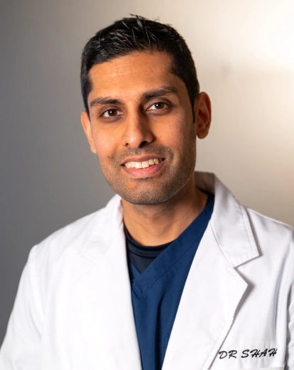 Portrait of Dr. Shah smiling in a white coat