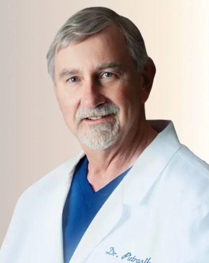 Portrait of Dr. Pietrasik smiling in a white coat
