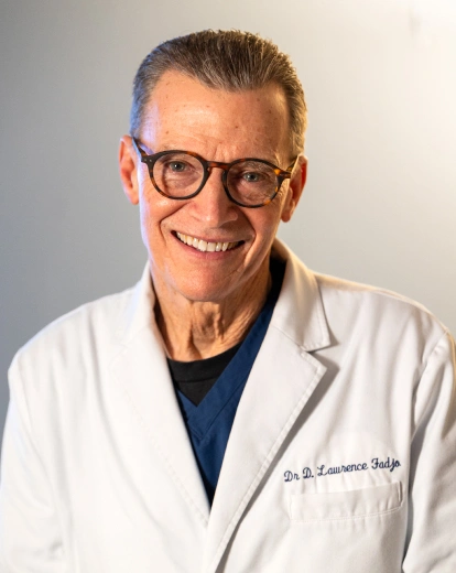 Portrait of Dr. Lawrence Fadjo smiling in a white coat