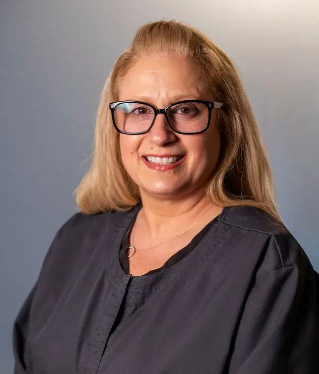 Karie Ann Therrien, dental professional at Chelmsford practice, smiling in portrait.